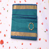 Silk cotton shot green saree with jari boarder.