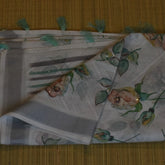 Elegant White Cotton Saree with Pine Green Floral Embellishments