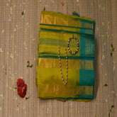 silk cotton yellow green saree with jari boarder