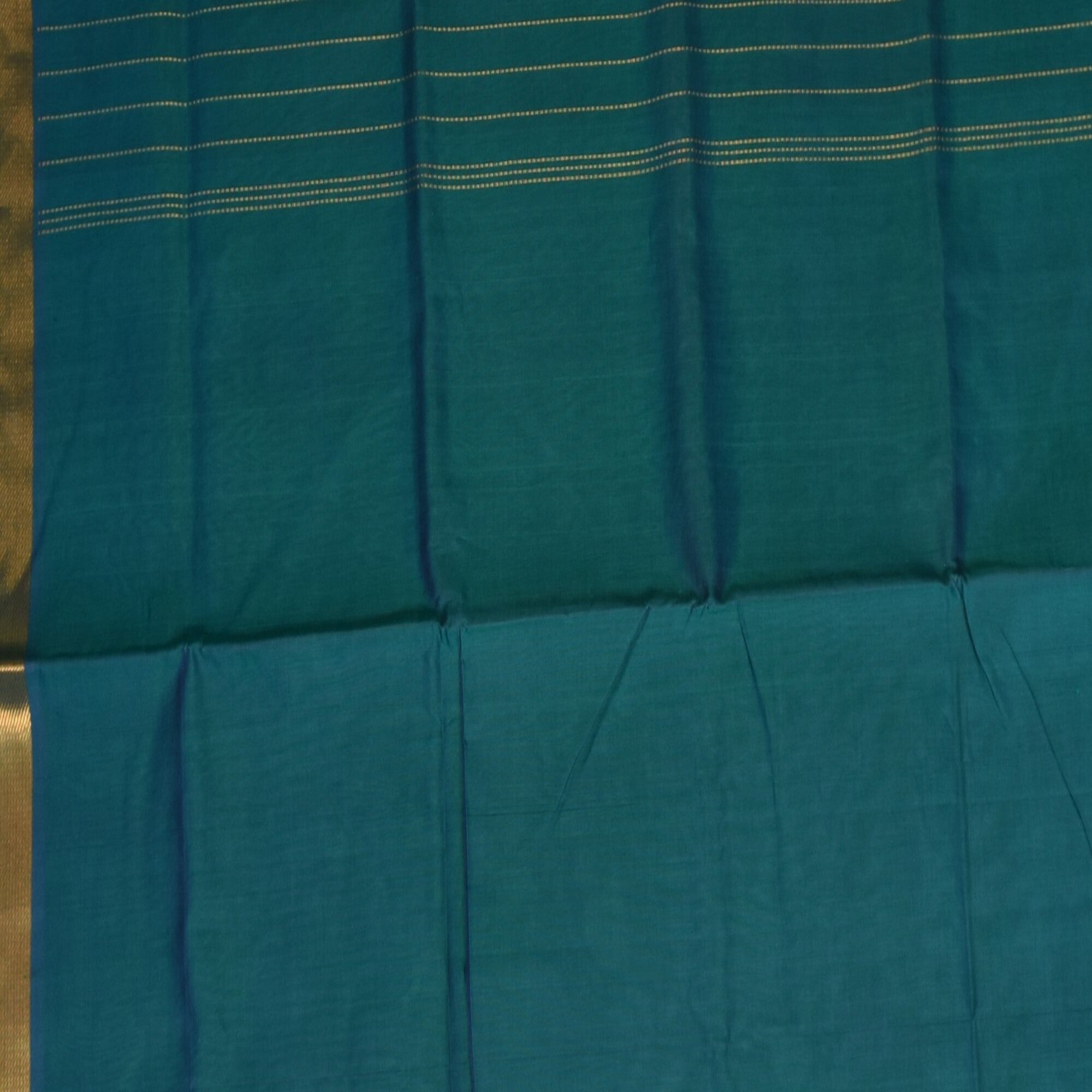 Silk cotton shot green saree with jari boarder.